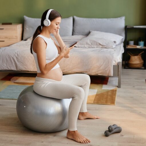 Pregnant Woman Exercising On Fitness Ball